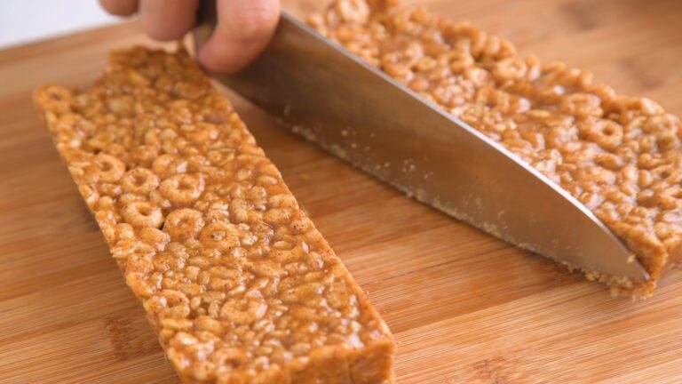 cutting homemade vegan rice krispy treats into bars