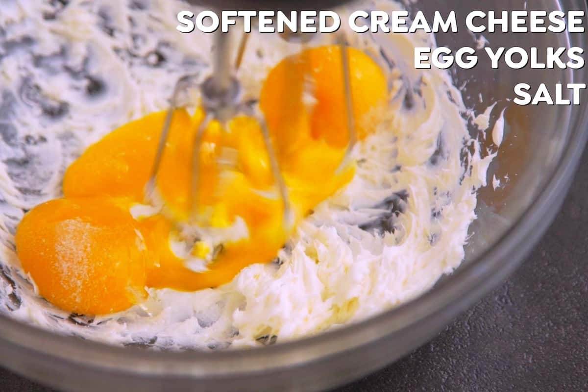 Beat softened cream cheese with a hand mixer until smooth and fluffy. Add egg yolks (and optional salt and/or sweetener).