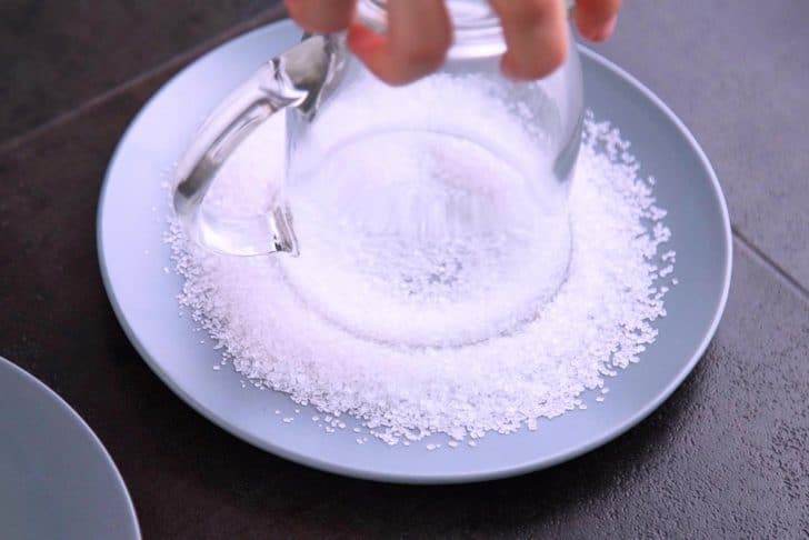 Dip rim of glass into a plate of lemon juice, then dip into a plate of sugar crystals to coat the rim.