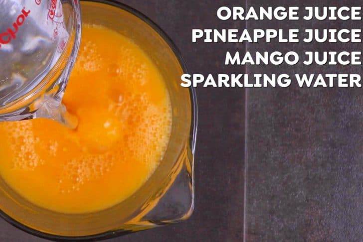 Combine all fruit juices and sparkling water in a large pitcher to make orange Halloween punch, then chill in the fridge for an hour before serving.