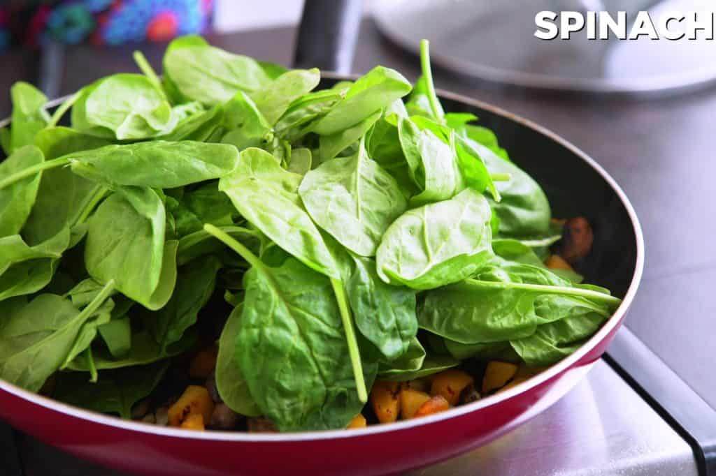 After 7-8 minutes, add spinach and cover to wilt for about 1 minute.