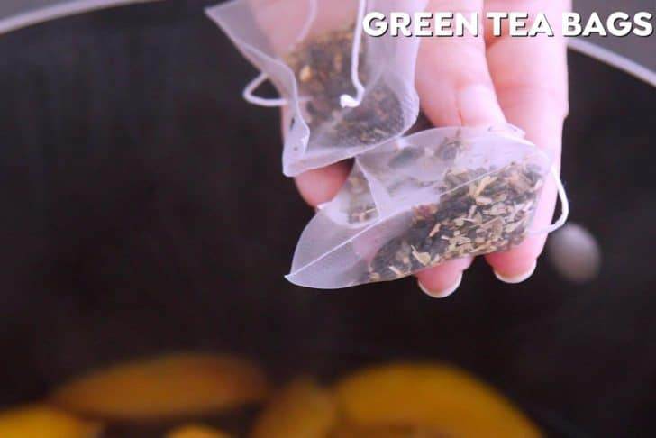 Add green tea bags to steep peach green tea