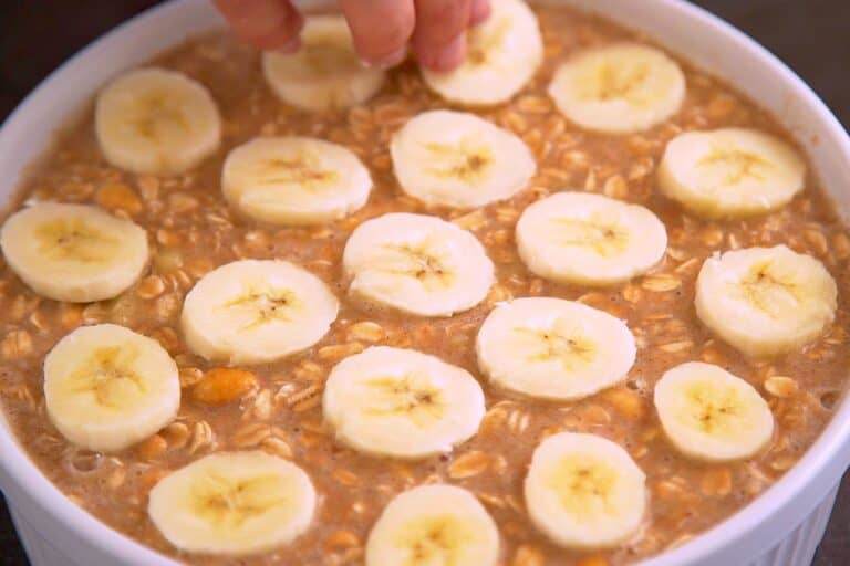 Transfer peanut butter banana oatmeal batter into a baking dish and top with sliced banana. Bake at 350°F (180°C) for 40-50 minutes.