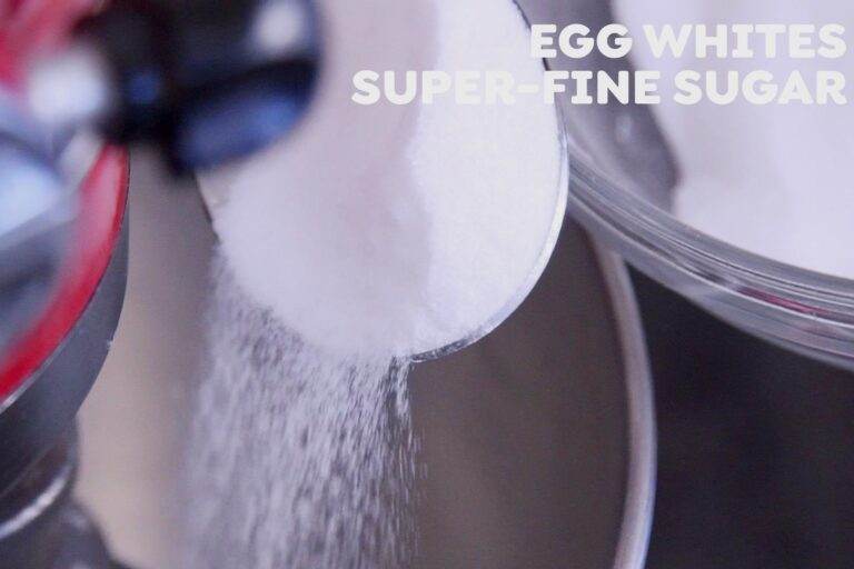 Slowly add superfine sugar one spoonful at a time, continuing to whisk for 6-10 minutes, until stiff peaks form.
