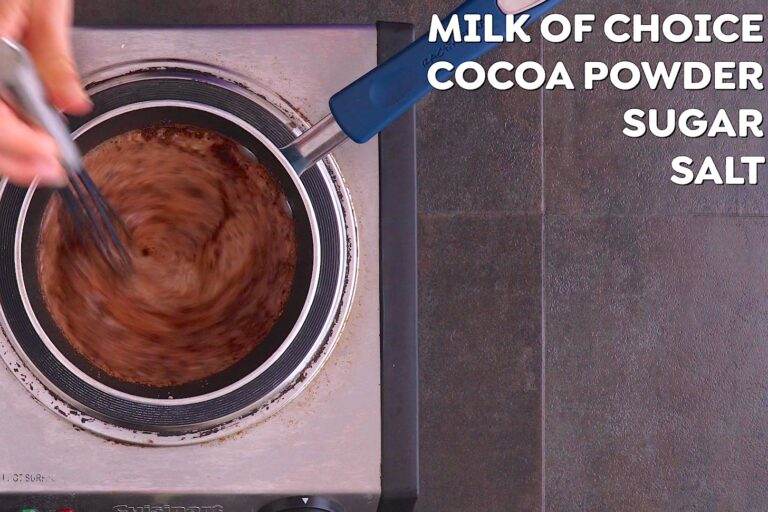 Heat milk of choice over medium-high heat, whisking vigorously to froth it up. Once simmering, whisk in cocoa powder, sugar, and salt.