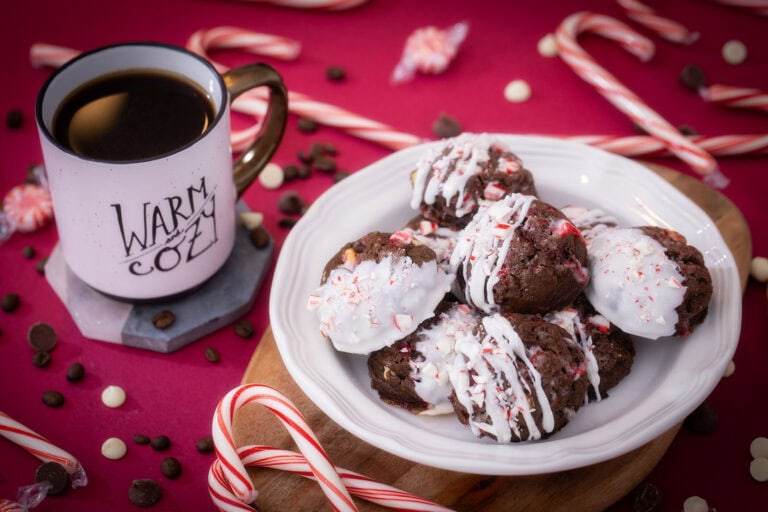 Peppermint mocha cookies on a red table next to a cup of coffee