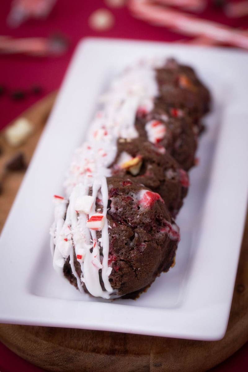 Peppermint mocha cookies on a long white plate on a red table surrounded by christmas decor