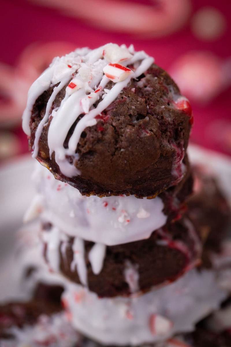 A close up shot of peppermint mocha cookies on a red table next to christmas decor