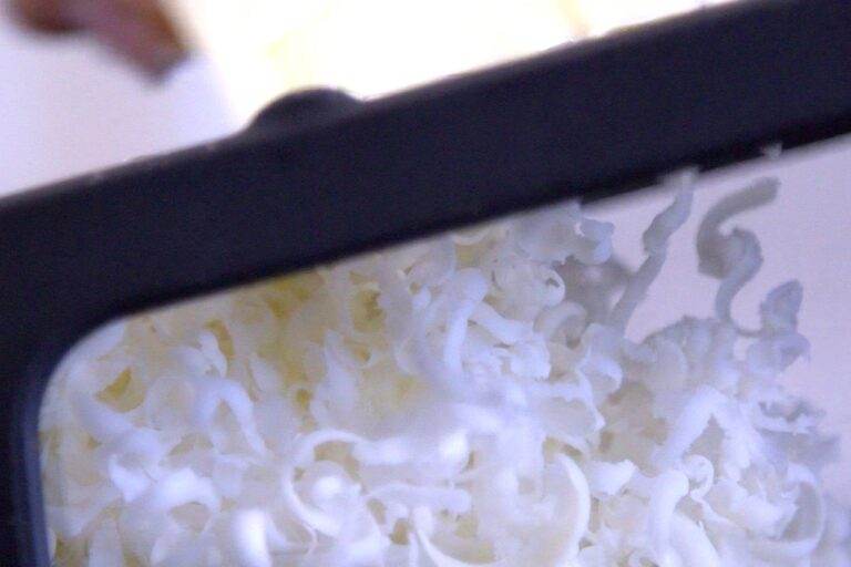 Grate frozen butter with a cheese grater.