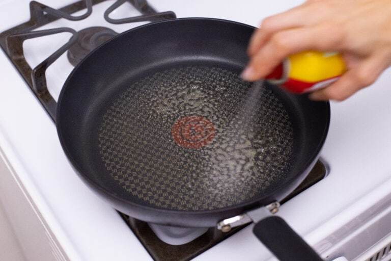 Spraying down a pan to prepare for cooking egg free tortillas