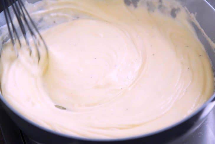 Prepare roux. Combine with milk and seasonings, whisking regularly for 5-6 minutes. Add shredded cheese of choice and stir until melted and creamy.