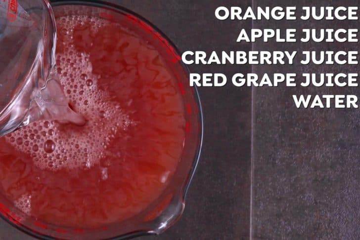 Combine all fruit juices and water for red Halloween punch in a large pitcher. Chill in the fridge for 1 hour before serving.