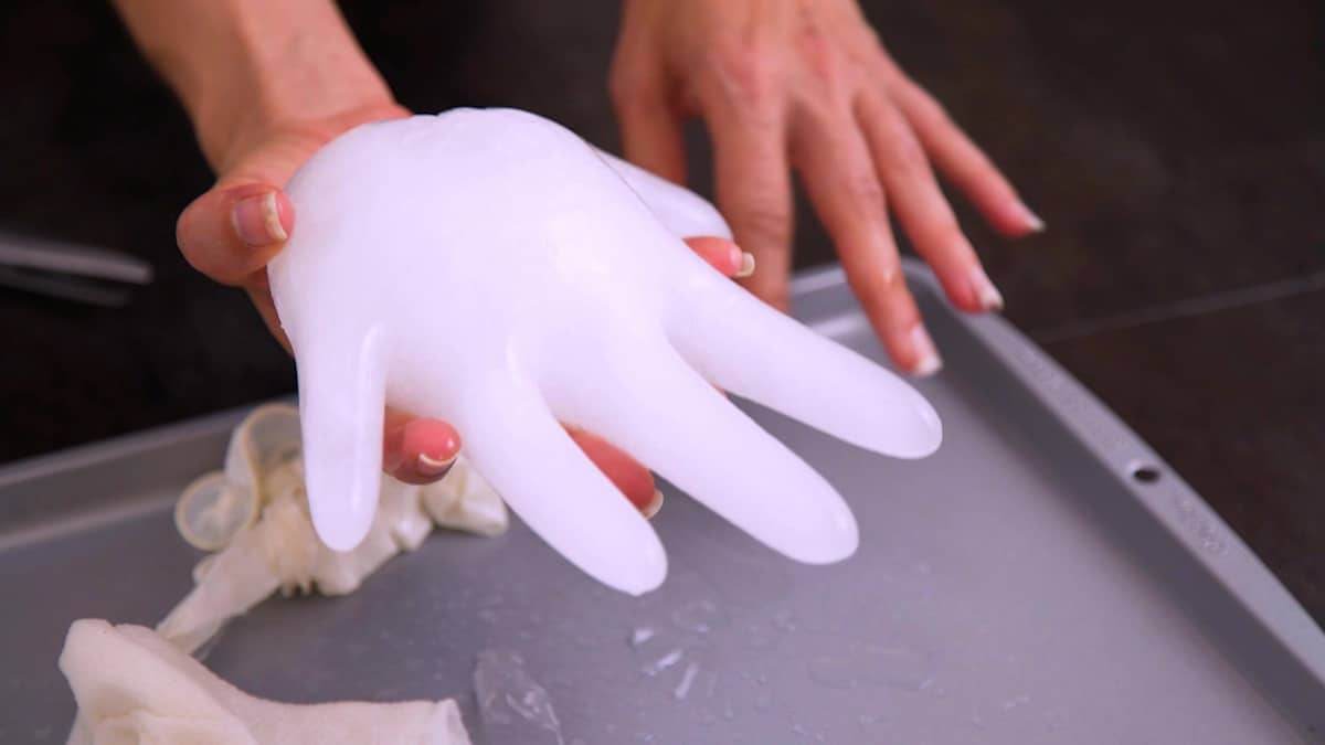 Remove glove completely and add ice hands into bowl with chilled blood punch.