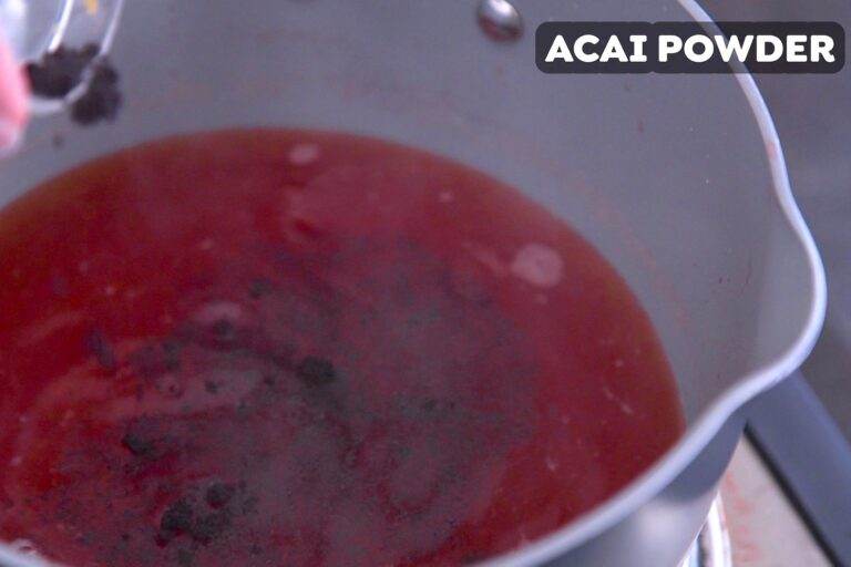 Discard strawberries after 5 minutes of simmering, then remove from heat & whisk in acai powder.