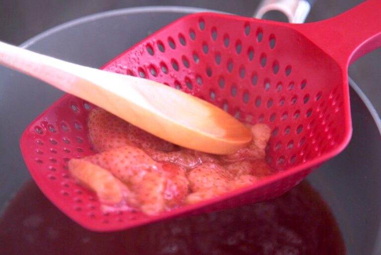 Remove pan from heat & scoop out strawberry pieces.