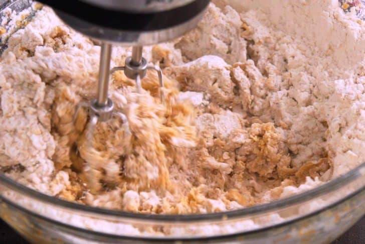 Gradually add dry mixture into wet mixture in 2-3 batches, beating to form a dough.
