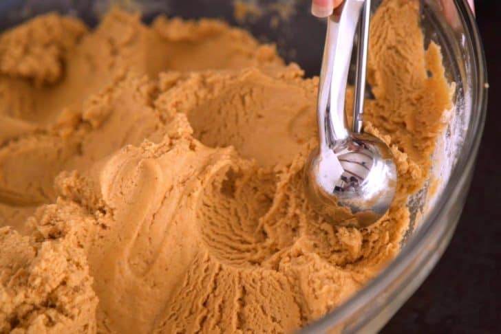 Portion sweet potato cookie dough with a cookie scoop and roll into balls.