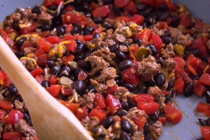 Cook meat and bean mixture with your favorite taco fillings.