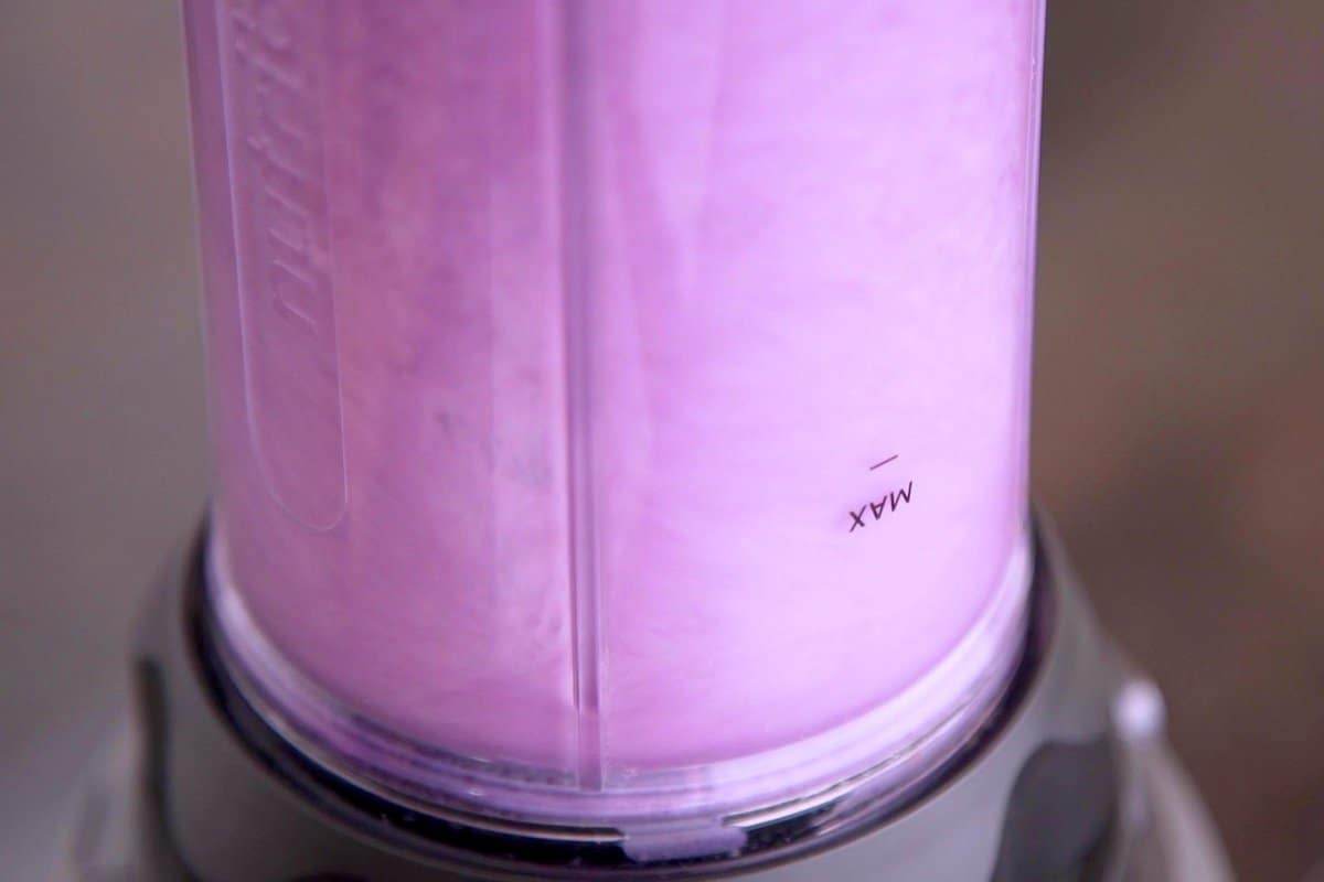 Add chilled milk tea, taro powder, and sweetener to a blender and blend until smooth.