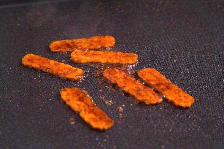Cook tempeh bacon on a griddle or in a pan over high heat.