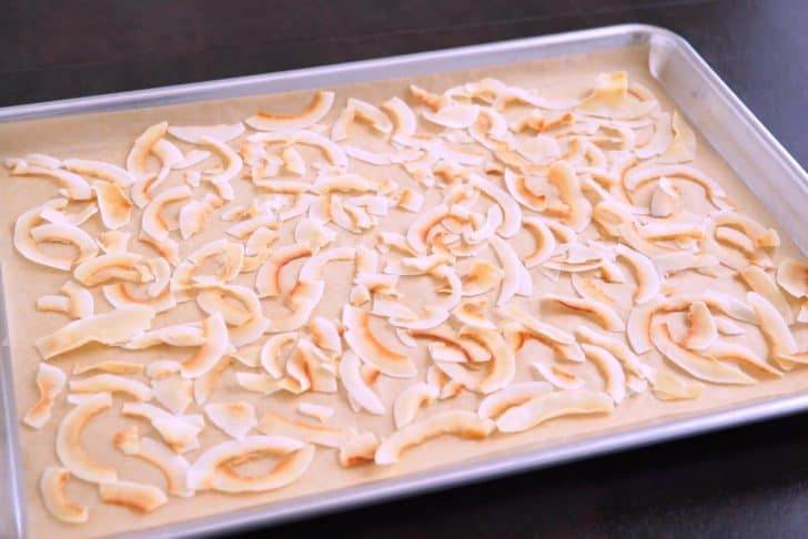 Bake coconut flakes for 3-5 minutes, until browned.