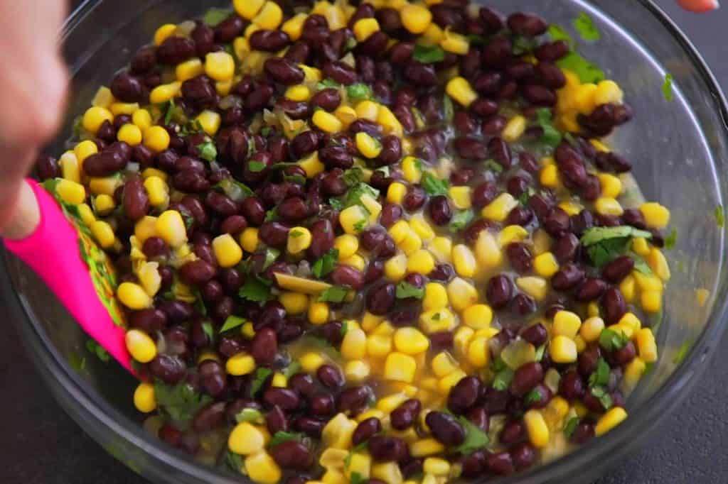 Combine corn, beans, 1 cup of enchilada sauce, ½ cup of salsa, and cilantro. Set aside.
