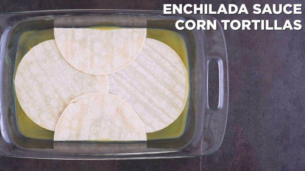 Add a layer of enchilada sauce to cover bottom of dish, followed by a layer of corn tortillas.