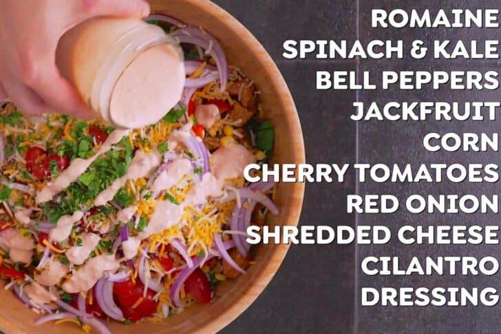 Add all salad ingredients to a large bowl, except for avocado.