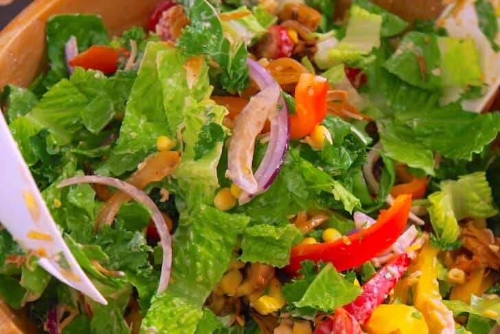 Toss salad well and serve in baked tortilla bowls.
